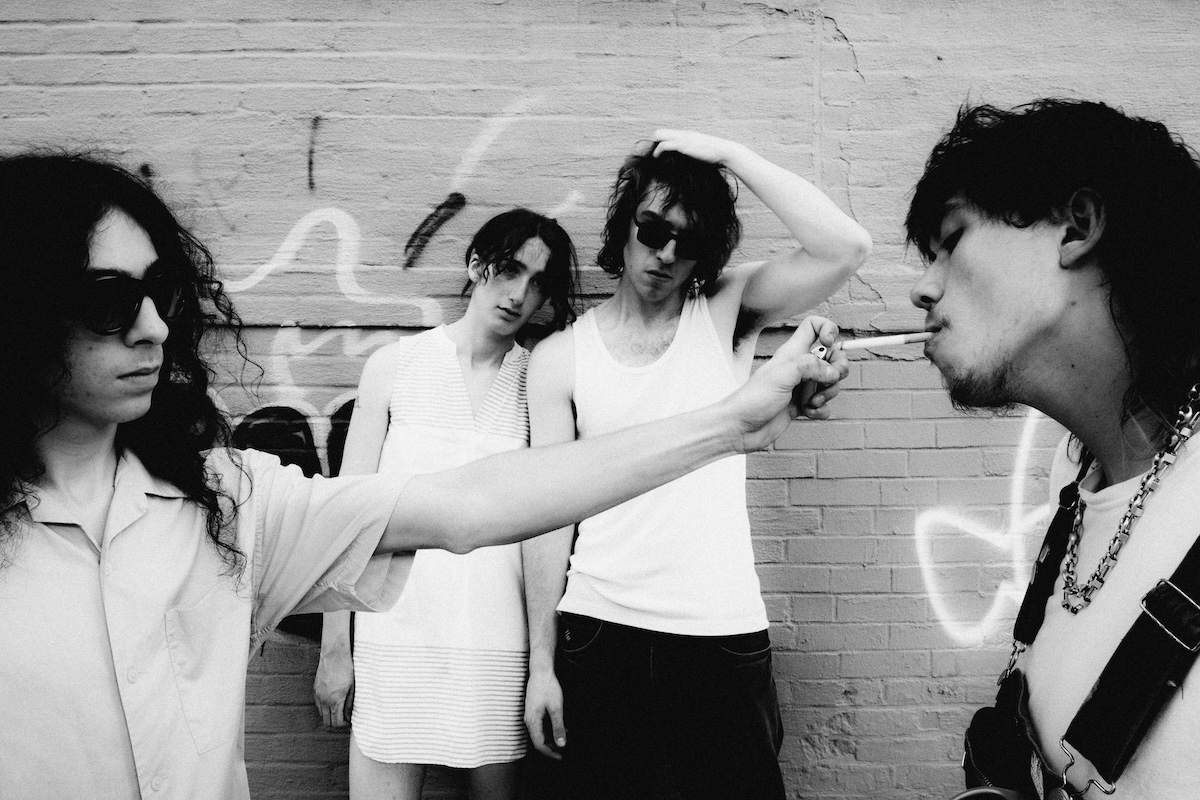 Black and white photo of American rock band Geese posing outdoors against a brick wall.